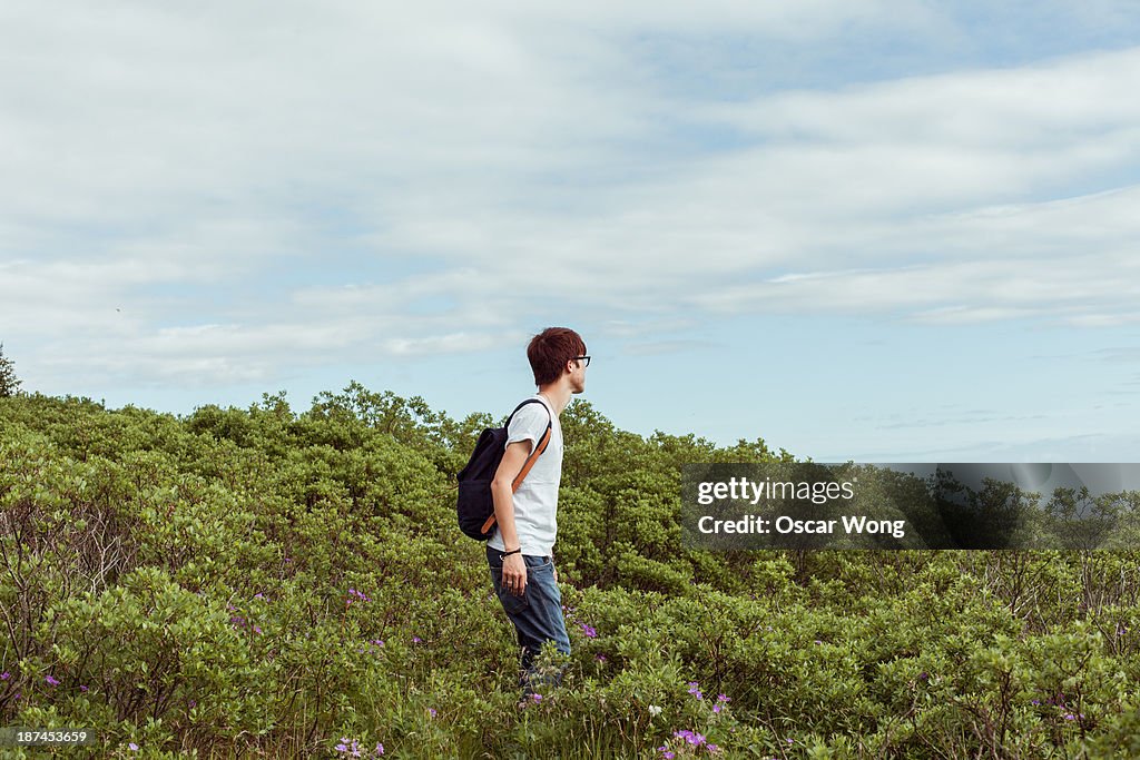 A young guy is walking in the wild