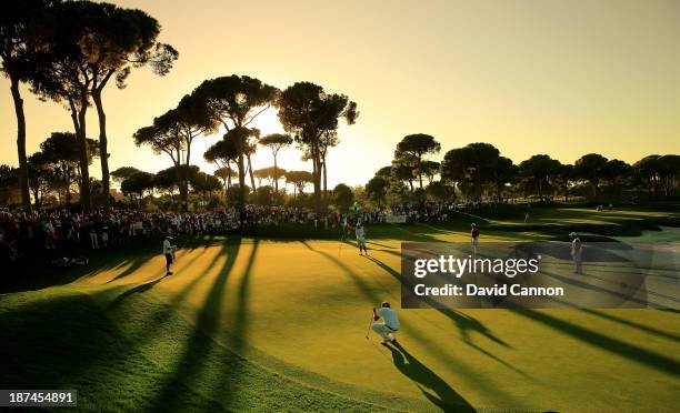 Victor Dubuisson of France in the foreground the third round leader lines up an eagle putt on the par 5, 18th green during the third round of the...