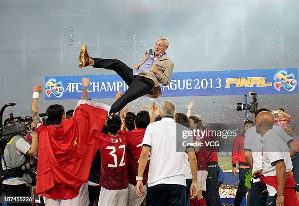 Guangzhou Evergrande players throw head coach Marcello Lippi up after winning the AFC Champions League Final 2nd leg match against FC Seoul at Tianhe...