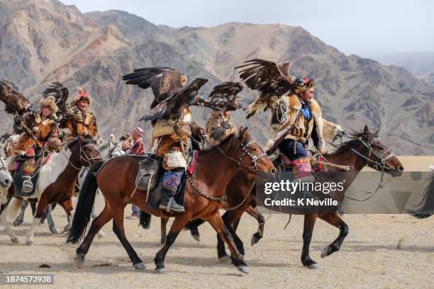 kazakh eagle hunters galloping on their horses - altai mountains stock pictures, royalty-free photos & images