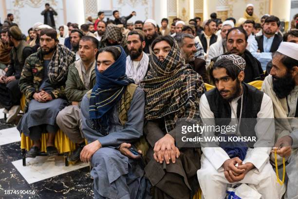 Relatives of grooms and brides attend a mass wedding ceremony at a wedding hall in Kabul on December 25, 2023. Fifty couples married on December 25...