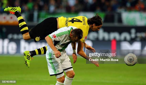 Ivica Olic of Wolfsburg and neven Subotic of Dortmund battle for the ball during the Bundesliga match between VfL Wolfsburg and Borussia Dortmund at...