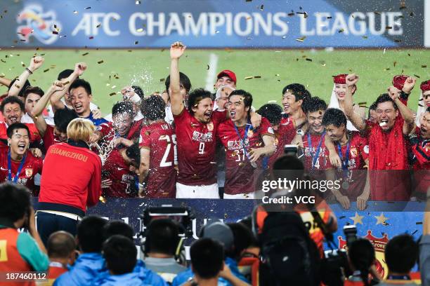 Guangzhou Evergrande players celebrate with the trophy after winning the AFC Champions League Final 2nd leg match against FC Seoul at Tianhe Sports...