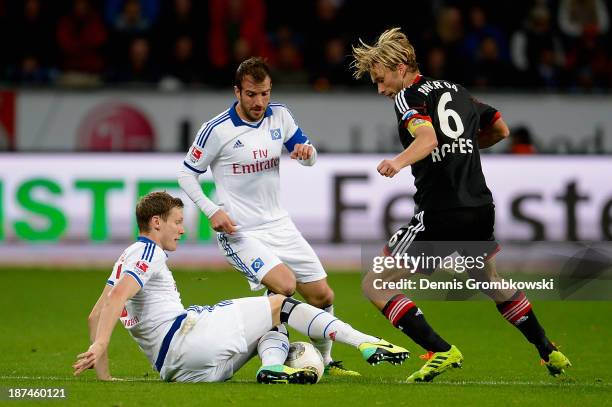 Marcell Jansen of Hamburger SV and Simon Rolfes of Bayer Leverkusen battle for the ball during the Bundesliga match between Bayer Leverkusen and...