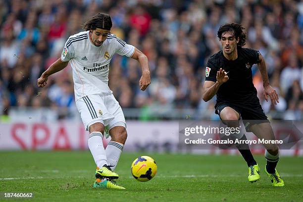 Sami Khedira of Real Madrid CF scores their fourth goal against Carlos Martinez of Real Sociedad during the La Liga match between Real Madrid CF and...