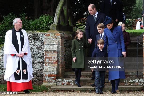 Revd Paul Williams stands bay as Britain's Prince William, Prince of Wales and Britain's Princess Charlotte of Wales , Britain's Catherine, Princess...