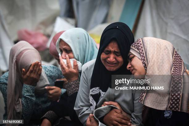 Palestinians mourn their relatives, killed in an overnight Israeli strike on the Al-Maghazi refugee camp, during a mass funeral at the Al-Aqsa...