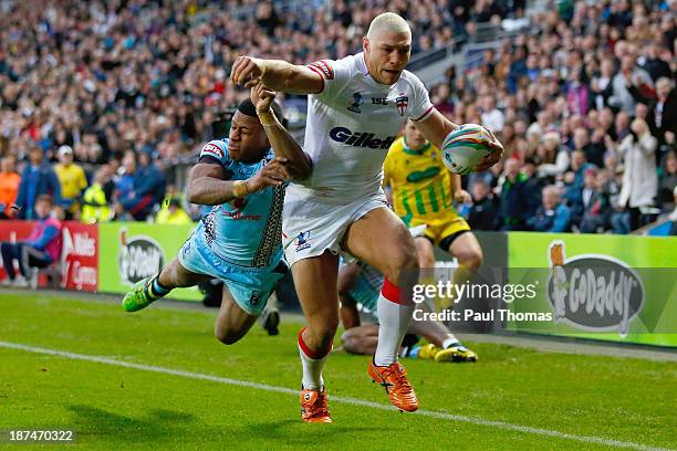 Ryan Hall of England runs into score his first try during the Rugby League World Cup Group A match at the KC Stadium on November 9, 2013 in Hull,...