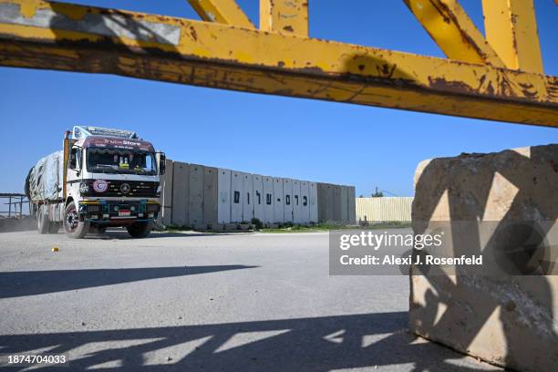 Trucks carrying humanitarian aid are checked on their way to Gaza at the Kerem Shalom Crossing after arriving from Egypt on December 22, 2023 in...