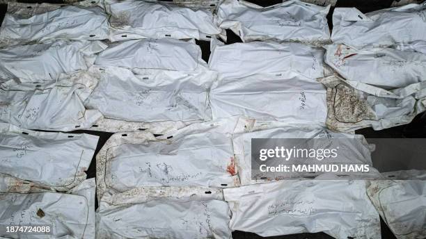 An aerial view shows shrouded bodies, killed in an overnight Israeli strike on the Al-Maghazi refugee camp, are layed out during a mass funeral at...