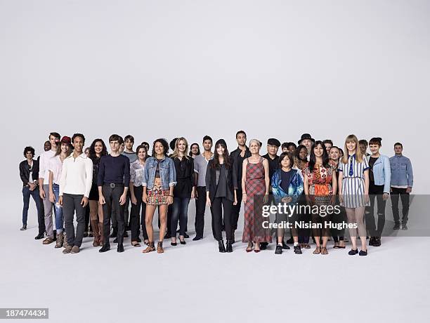 large group of people standing together in studio - girls with short skirts photos et images de collection