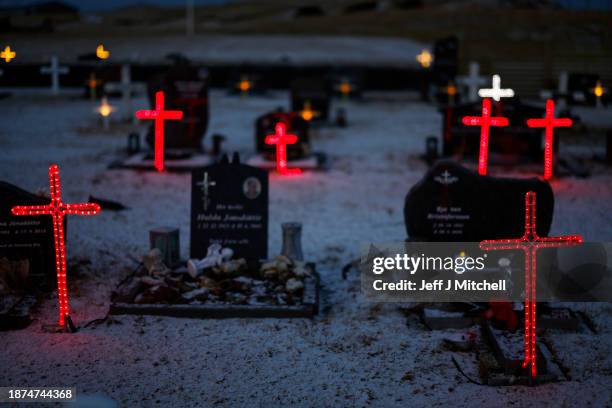 View of illuminated crosses in Grindavik Cemetery, the town was evacuated due to the eruption that happened four kilometres north on December 22,...