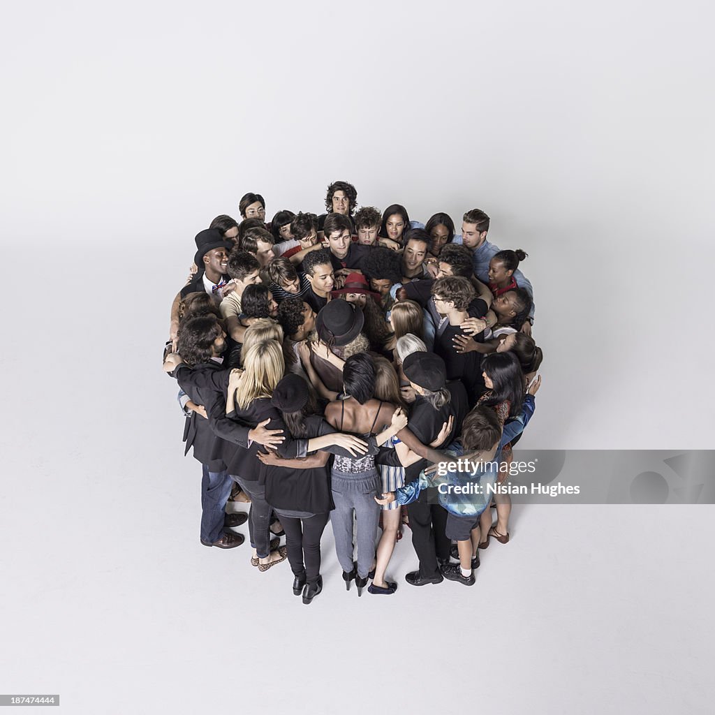 Large group of people standing together hugging