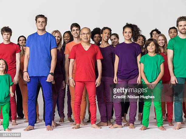 large group of people standing together in studio - multi coloured trousers stockfoto's en -beelden