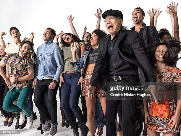 group of people celebrating and jumping in the air - asian woman black shirt stock pictures, royalty-free photos & images