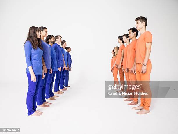two groups of people in rows - 人の列 ストックフォトと画像