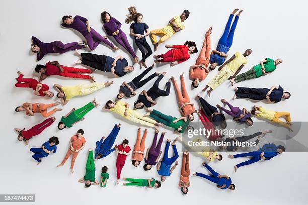 group of people lying on studio floor - reclining stock pictures, royalty-free photos & images
