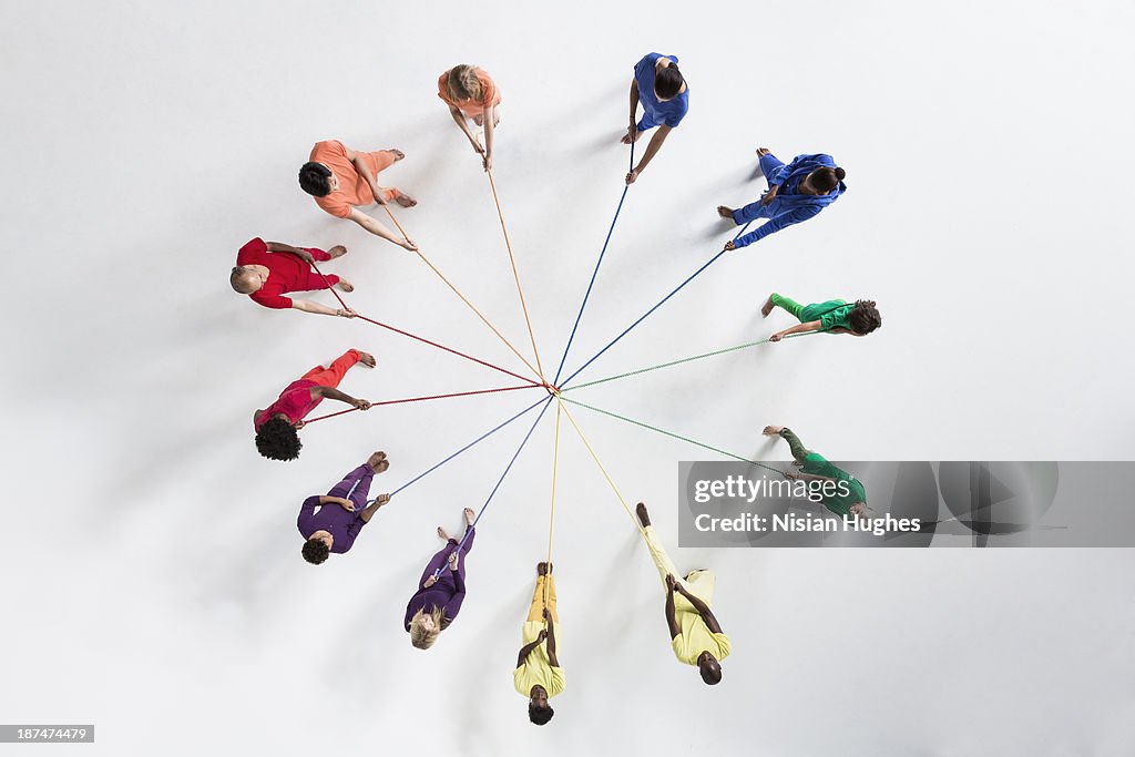 Circle of People Pulling on Connected Ropes