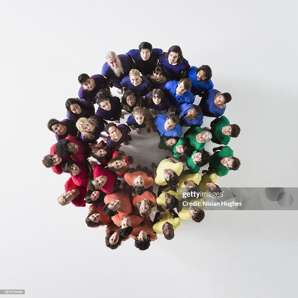 People in a Circle Looking Up and Smiling