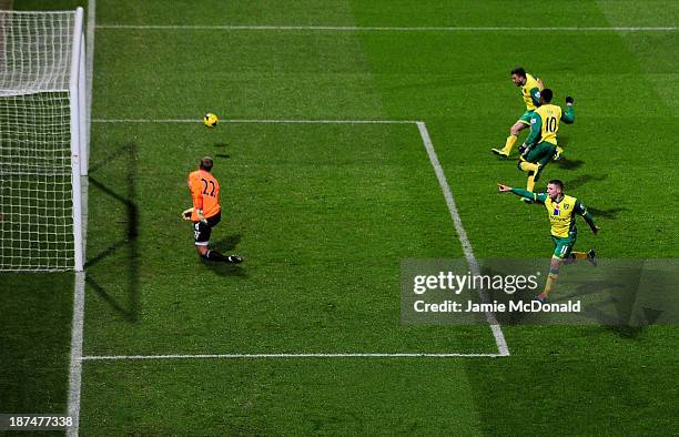 Despair for Jussi Jaaskelainen of West Ham United as Gary Hooper of Norwich City celebrates scoring their first goal from the penalty spot during the...