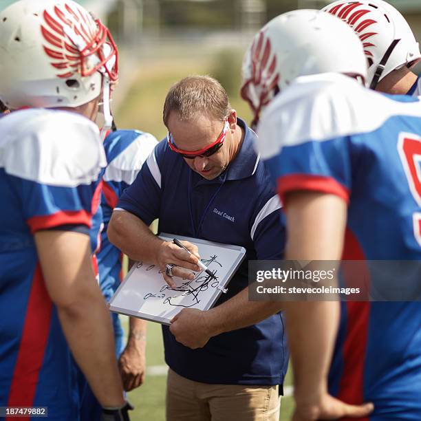 football coach and players - american football coach stock pictures, royalty-free photos & images