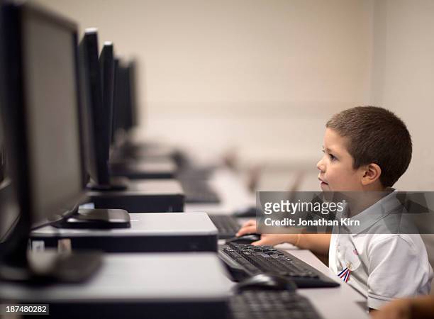 first grade school children learn on computers. - learning stock pictures, royalty-free photos & images