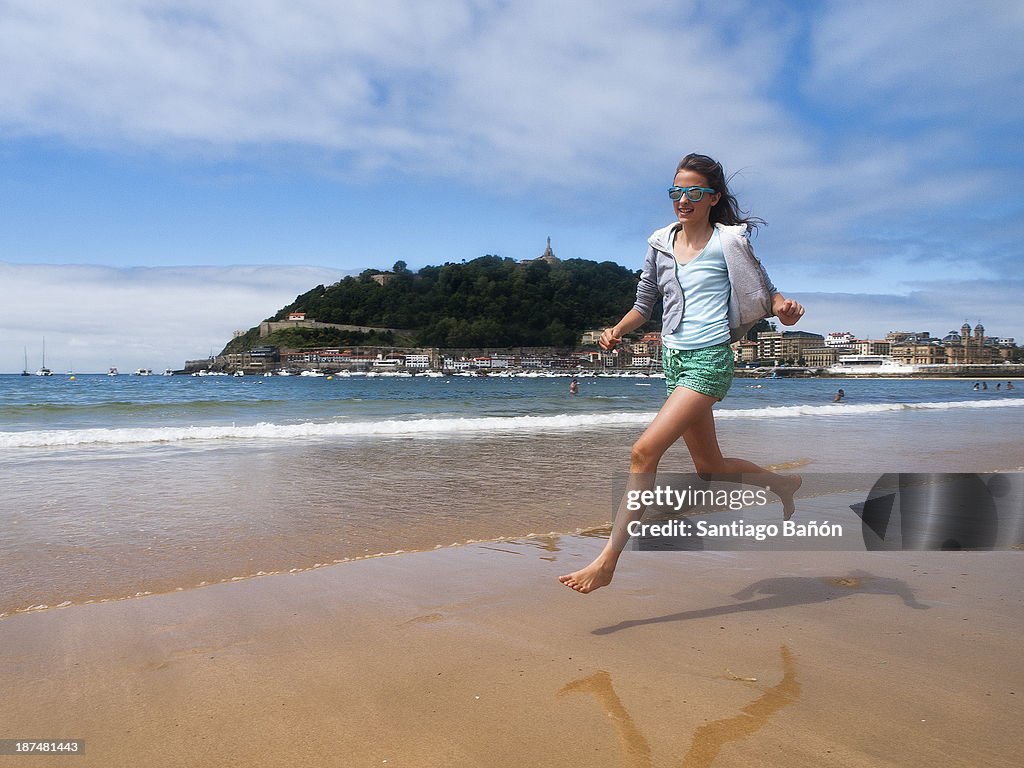 Girl jumping at the beach in Sansebastian