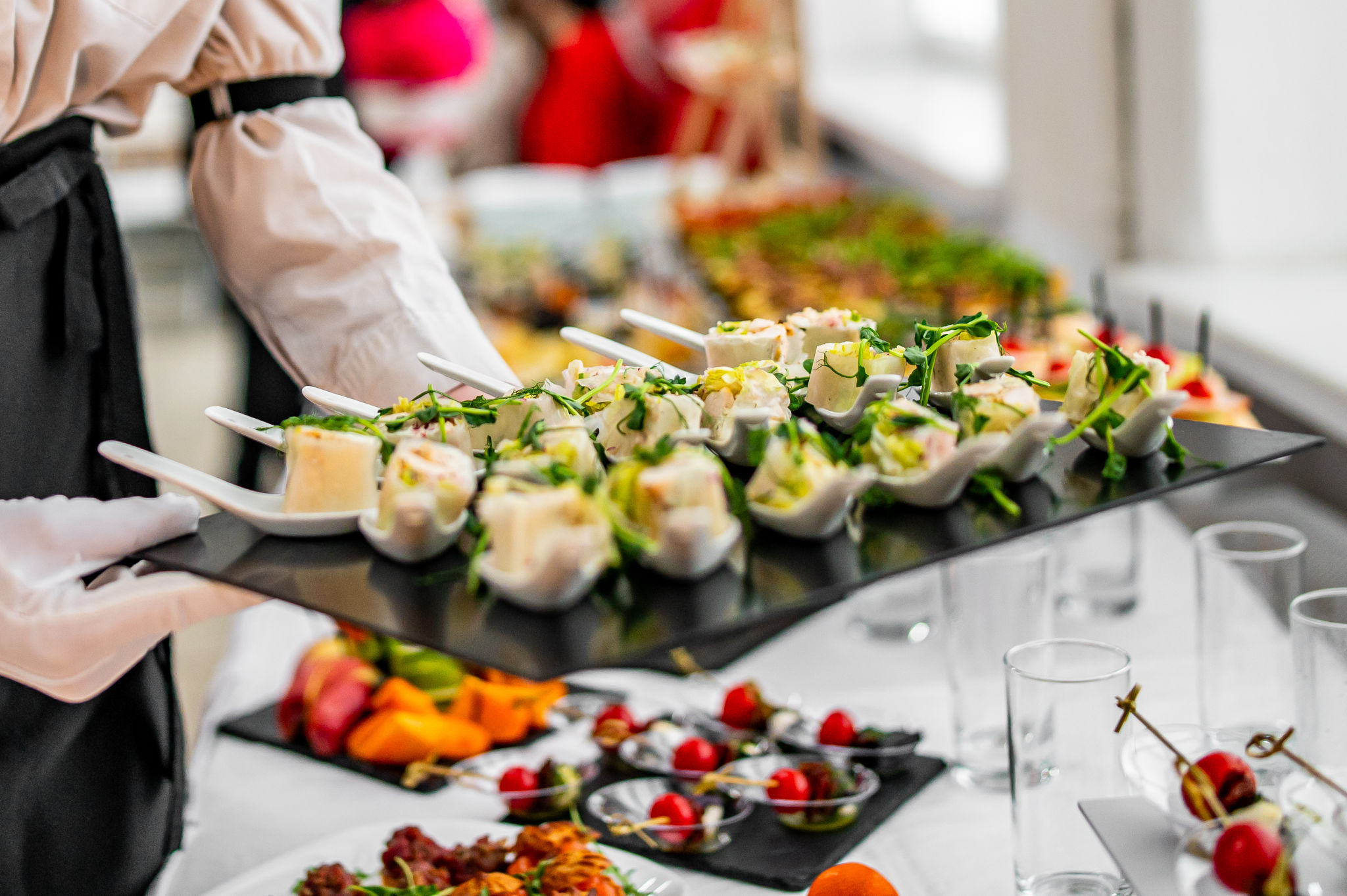 woman hands of a waiter prepare food for a buffet table in a restaurant woman hands of a waiter prepare food for a buffet table in a restaurant