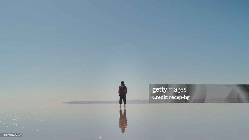 Asian female tourist walking in salt lake in Turkiye, Turkey