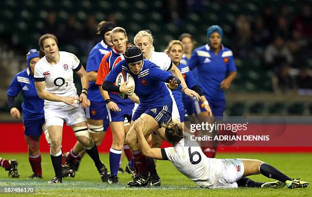 France's Manon Andre is tackled by England's Marlie Packer during the International women's rugby union test match between England and France at...