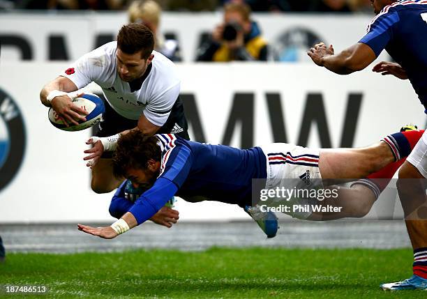 Cory Jane of the All Blacks is tackled out of touch by Maxime Medard of France during the international test match between France and the New Zealand...