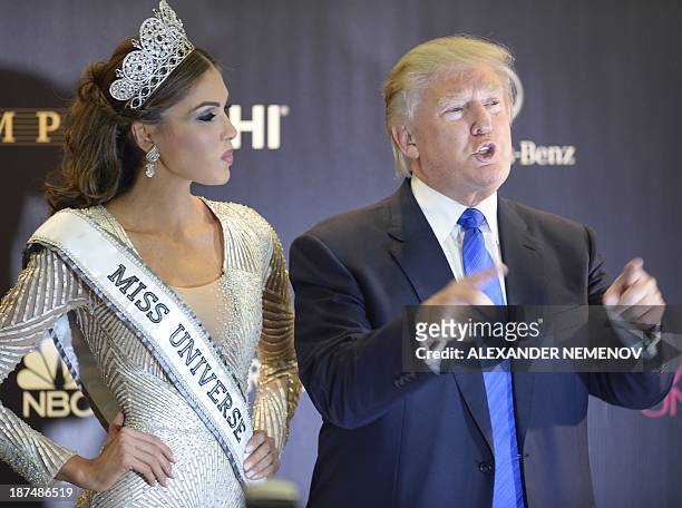 Co-owner if the Miss Unioverse Organization US billionaire Donald Trump poses next to Miss Venezuela and Miss Universe 2013 Gabriela Isler after the...