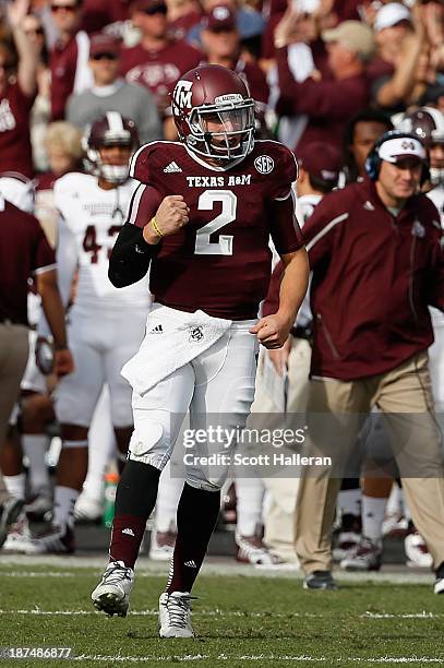 Johnny Manziel of the Texas A&M Aggies celebrates after tossing a 12 yard touchdown pass in the first quarter during the game against the Mississippi...