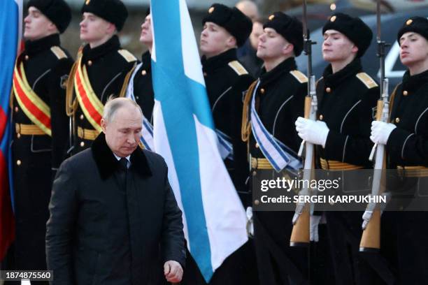 This pool photograph distributed by Russian state agency Sputnik, shows Russia's President Vladimir Putin inspects a guard of honour during a...