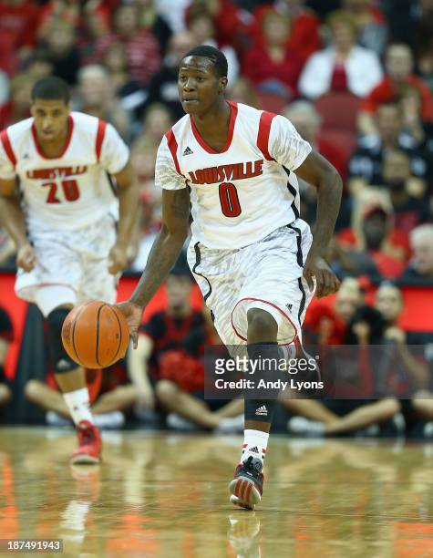 Terry Rozier of the Louisville Cardinals dribbles the ball during the game against the College of Charleston Cougars at KFC YUM! Center on November...