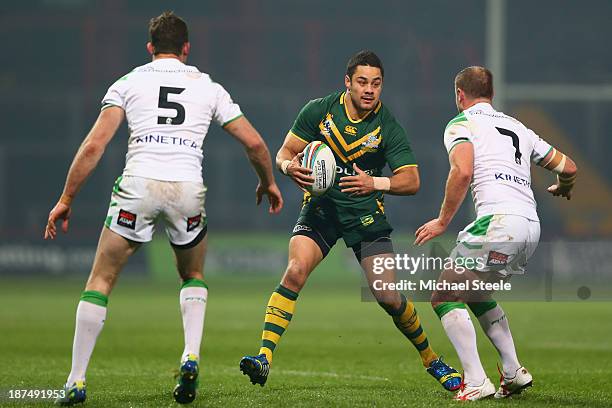 Jarryd Hayne of Australia runs at Pat Richards and Liam Finn of Ireland during the Rugby League World Cup Group A match between Australia and Ireland...