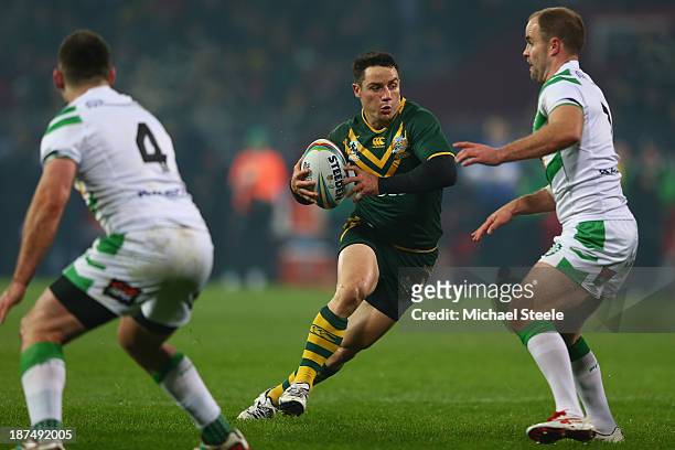 Cooper Cronk of Australiacuts between Liam Finn and Joshua Toole of Ireland during the Rugby League World Cup Group A match between Australia and...