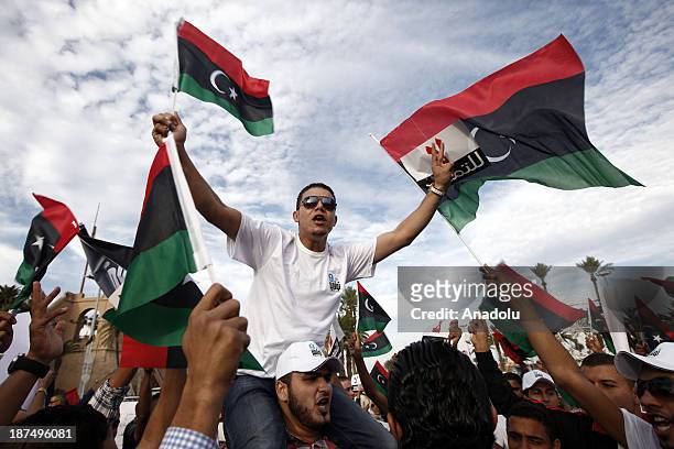 Hundreds of Libyans gathered in Martyrs Square, shout slogans during a protest against an extended mandate of the General National Congress on...