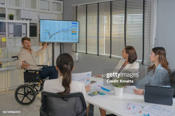 disabled businessman giving presentation to colleagues in meeting room. - inclusion body stock-fotos und bilder