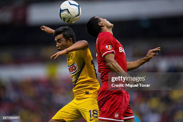Christian Bermudez of America fights for the ball with Paulo Da Silva of Toluca during a match between America and Toluca as part of the Apertura...