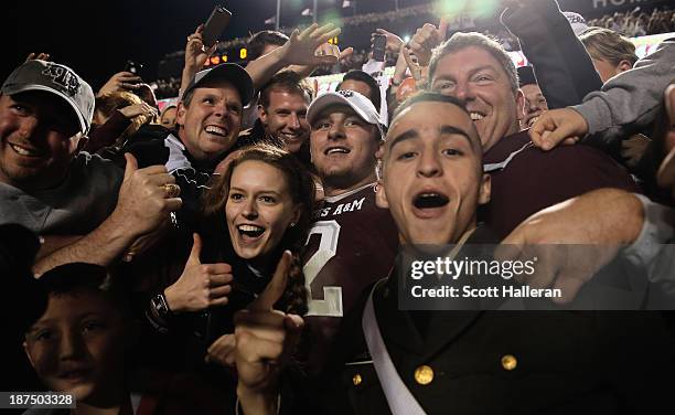 Johnny Manziel of the Texas A&M Aggies celebrates with fans after the Aggies defeated the Mississippi State Bulldogs 51-41 at Kyle Field on November...