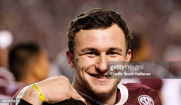 Johnny Manziel of the Texas A&M Aggies waits near the bench late in the fourth quarter during the game against the Mississippi State Bulldogs at Kyle...