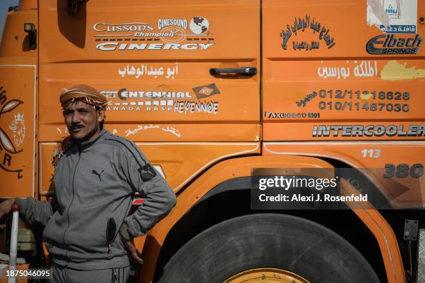 Egyptian truck drivers hauling humanitarian aid wait to cross into Gaza at the Kerem Shalom Crossing after arriving from Egypt and being checked on...