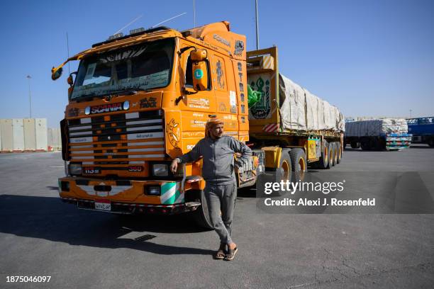 Egyptian truck drivers hauling humanitarian aid wait to cross into Gaza at the Kerem Shalom Crossing after arriving from Egypt and being checked on...