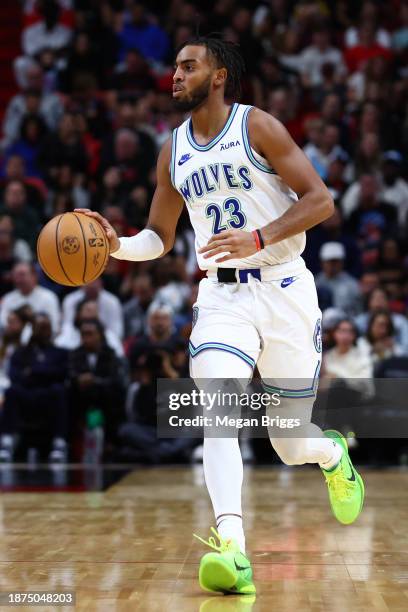 Troy Brown Jr. #23 of the Minnesota Timberwolves dribbles the ball against the Miami Heat during the first quarter at Kaseya Center on December 18,...