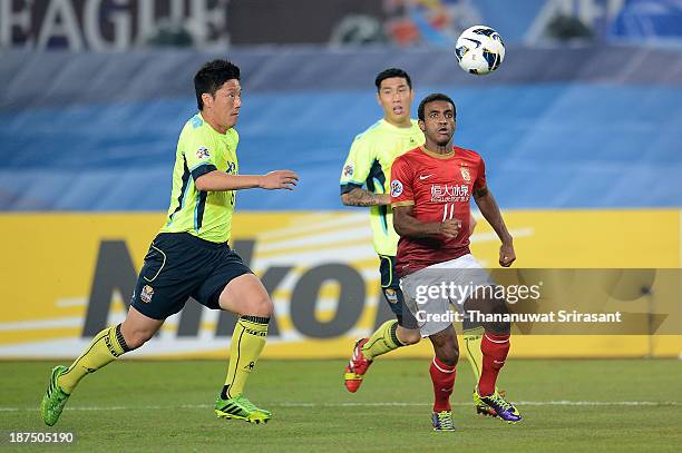 Luiz Muriqui of Guangzhou Evergrande competes for the ball with Kim Jin Kyu of FC Seoul during the AFC Champions League Final 2nd leg match between...