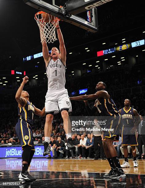 Mason Plumlee of the Brooklyn Nets dunks the ball over Orlando Johnson of the Indiana Pacers during the second quarter at Barclays Center on November...