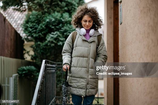 woman leaves the house - jacket stock pictures, royalty-free photos & images