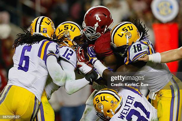 Yeldon of the Alabama Crimson Tide rushes against Corey Thompson, Craig Loston, D.J. Welter and Lamin Barrow of the LSU Tigers during the fourth...