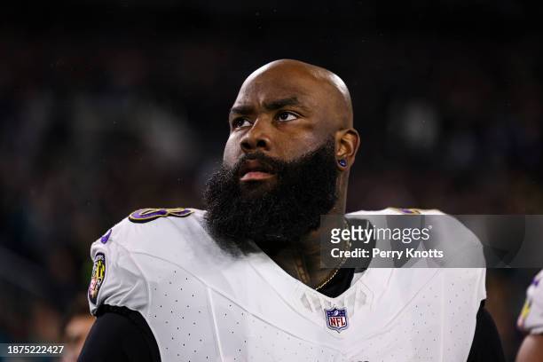 Morgan Moses of the Baltimore Ravens looks on from the sideline during the national anthem prior to an NFL football game against the Jacksonville...